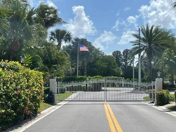a view of a park with iron fence