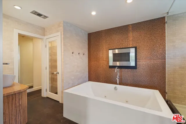 a bathroom with a bathtub and a shower