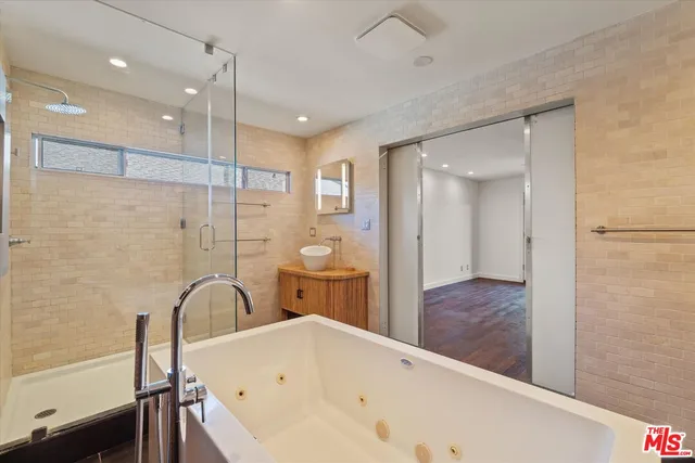 a bathroom with a bathtub and a shower