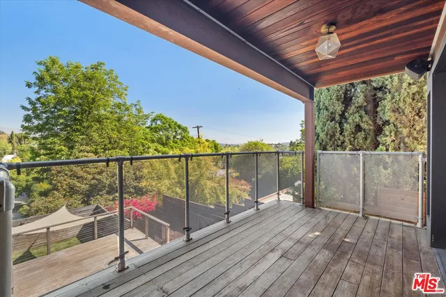 a view of a balcony with wooden floor