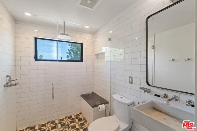 a bathroom with a toilet sink and shower