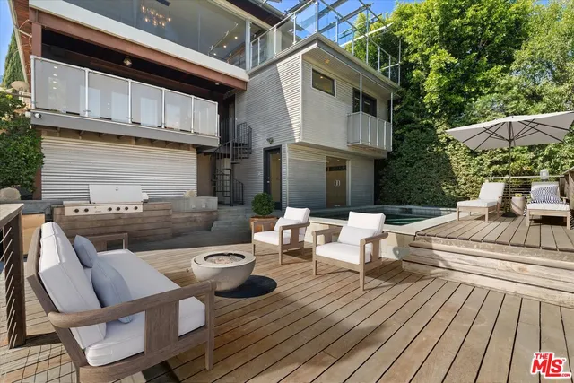 a view of a patio with table and chairs and potted plants