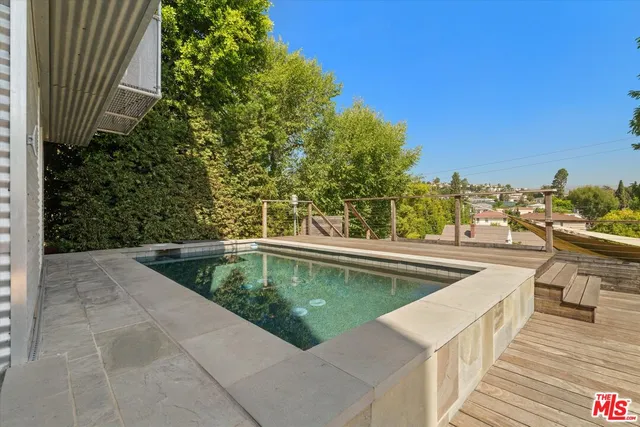 a view of a swimming pool with a patio