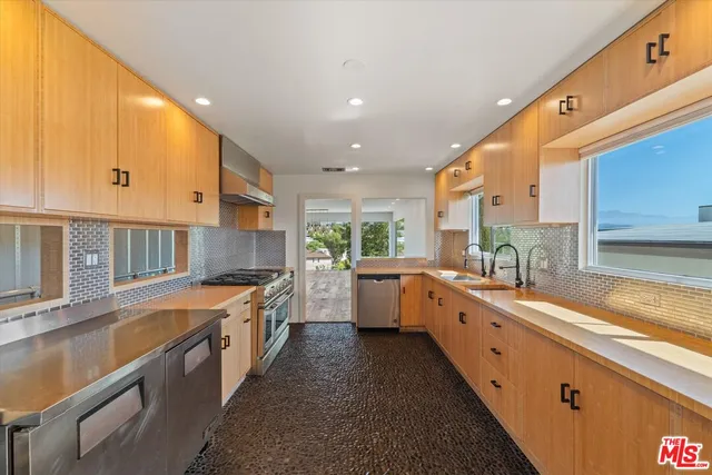 a kitchen with a sink stove and cabinets