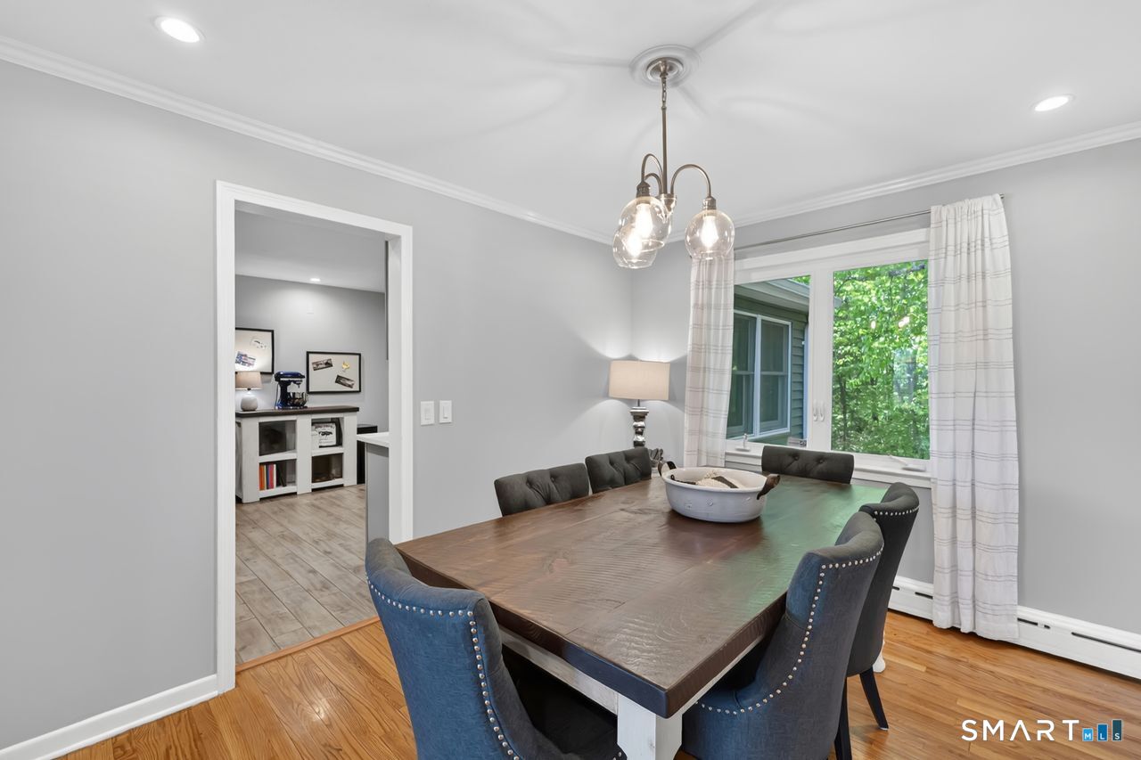1013 Ratley Road Suffield, CT 06093 - Photo 12 of 39 a view of a dining room with furniture window and wooden floor