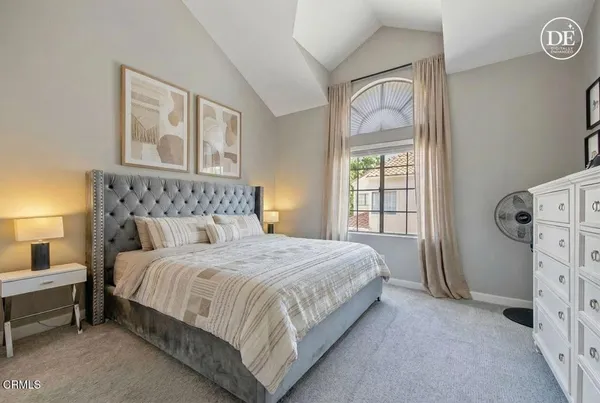 a bedroom with a bed next to a window with outer view