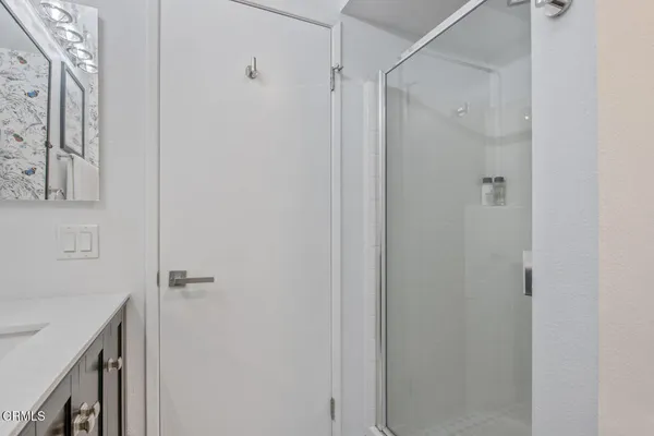 a bathroom with a shower and a sink