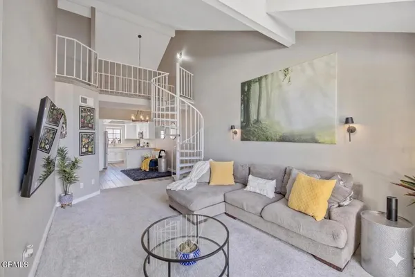 a living room with furniture and a lamp