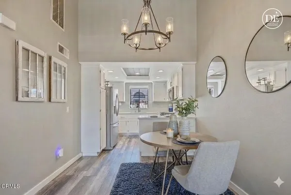 a view of a dining room with furniture and a chandelier