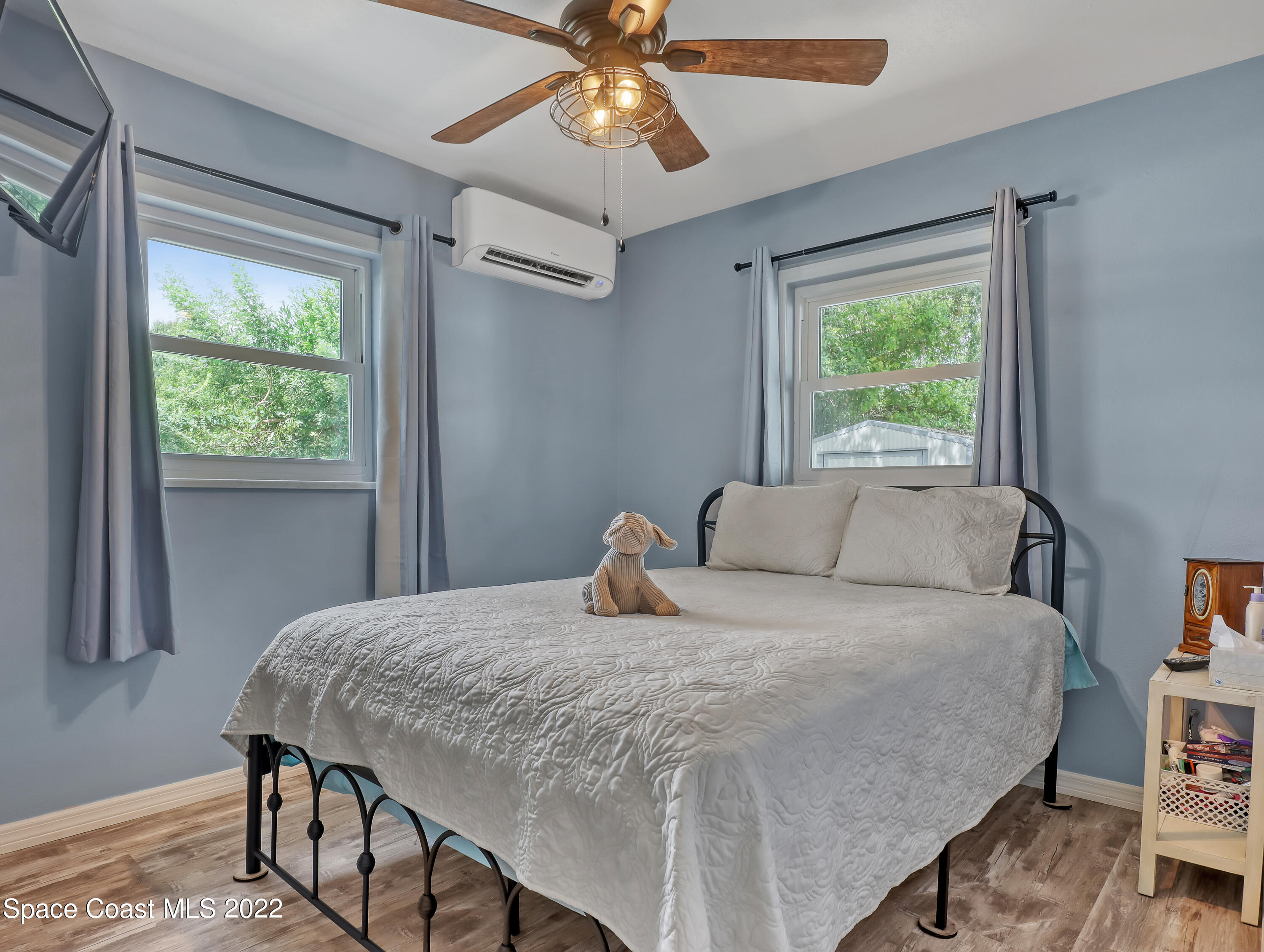 2156 King Richard Road Melbourne, FL 32935 - Photo 13 of 28 a bedroom with a bed and a chandelier