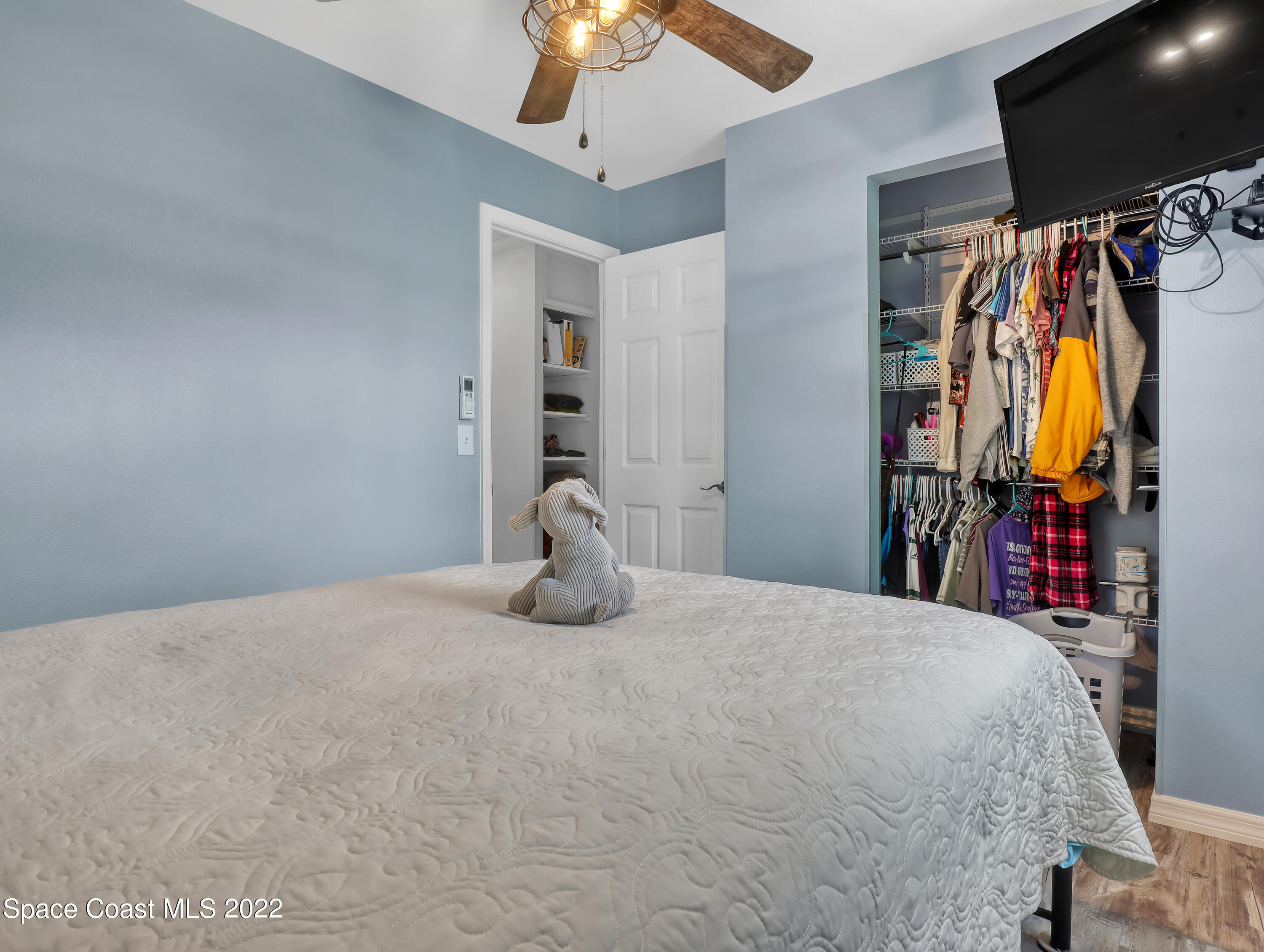 2156 King Richard Road Melbourne, FL 32935 - Photo 14 of 28 a bed room with a bed and a walk in closet
