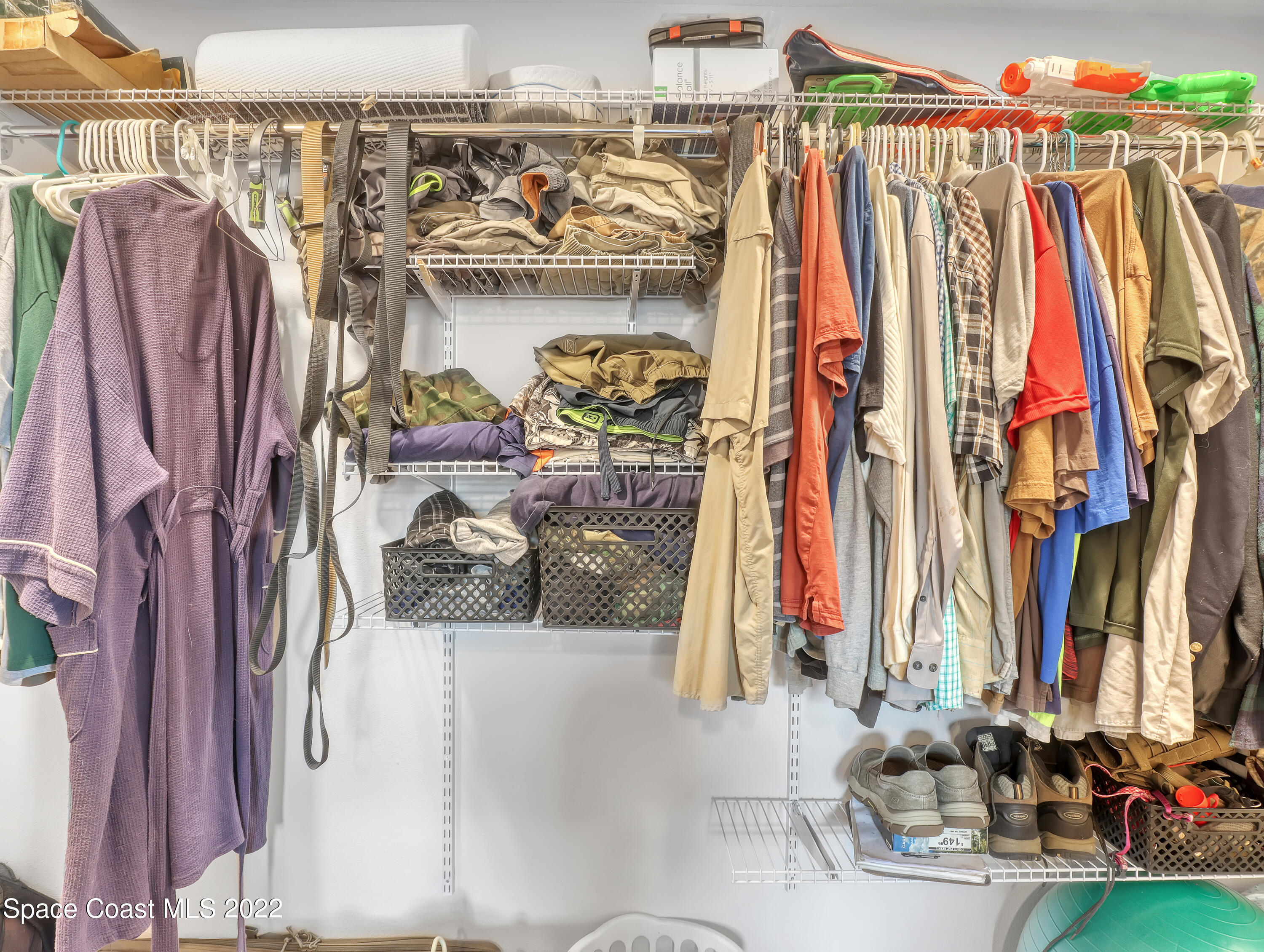 2156 King Richard Road Melbourne, FL 32935 - Photo 15 of 28 a view of walk in closet with clothes and shoes