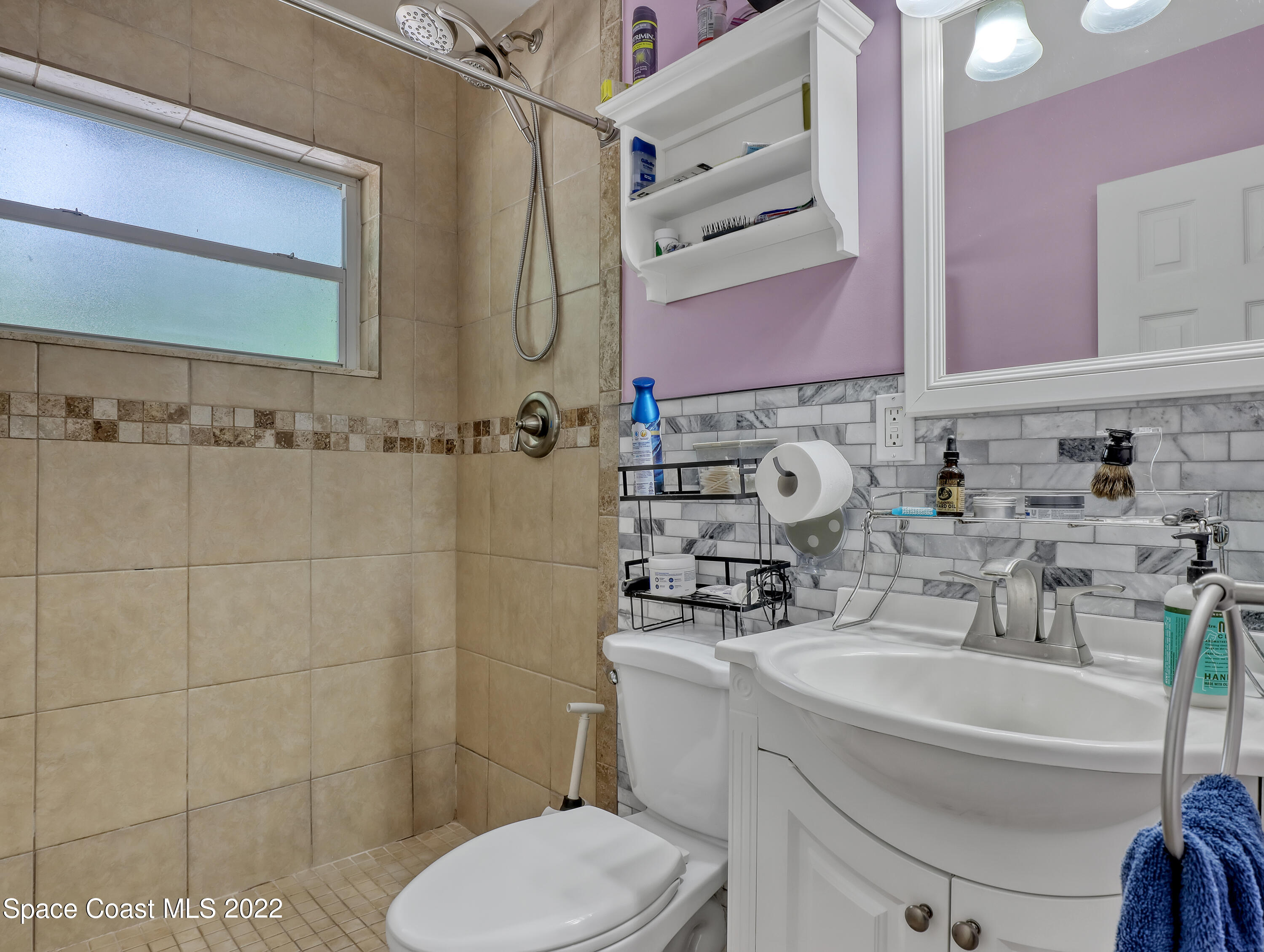 2156 King Richard Road Melbourne, FL 32935 - Photo 19 of 28 a bathroom with a toilet sink and mirror