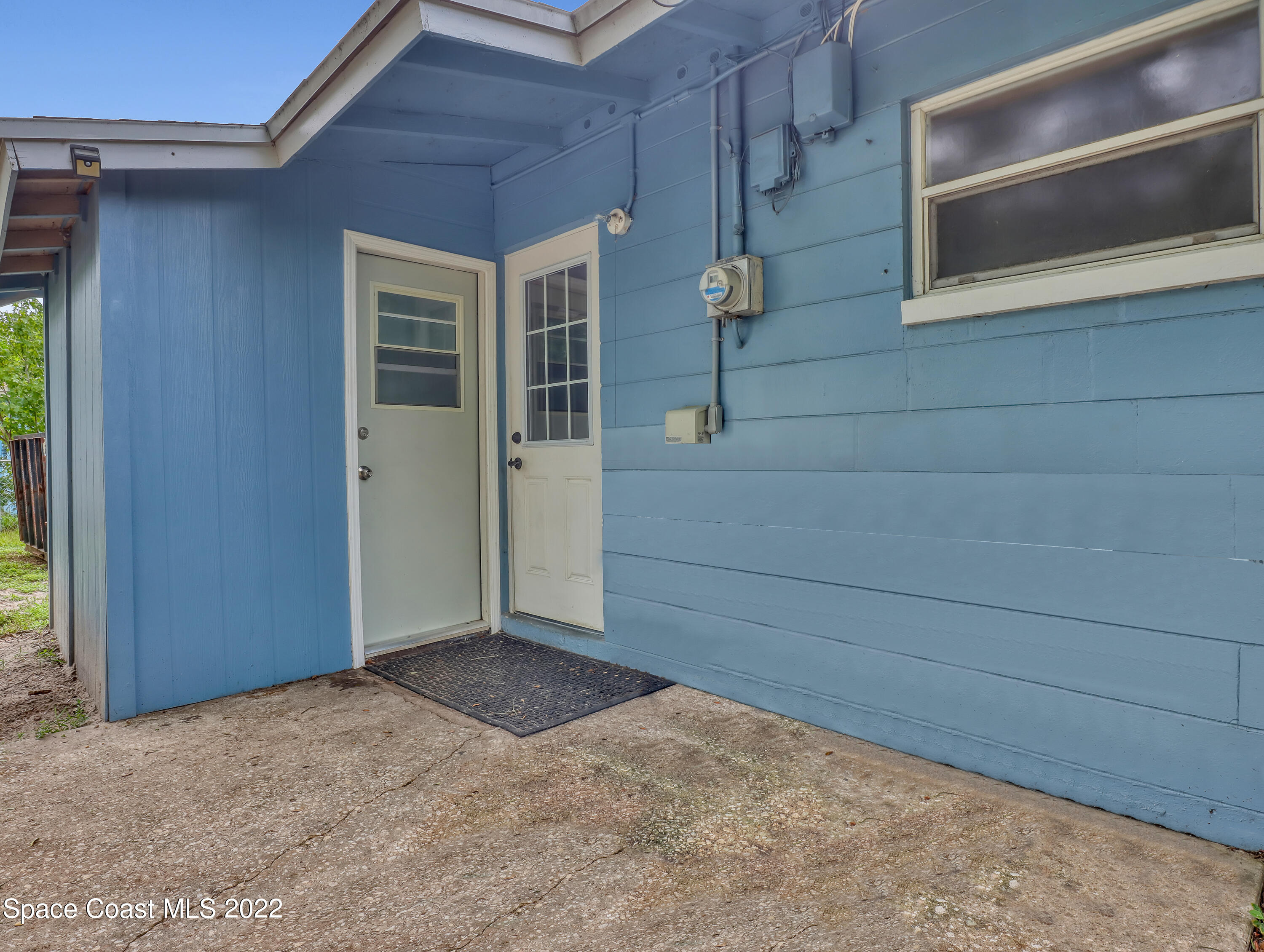 2156 King Richard Road Melbourne, FL 32935 - Photo 20 of 28 a view of front door and bedroom
