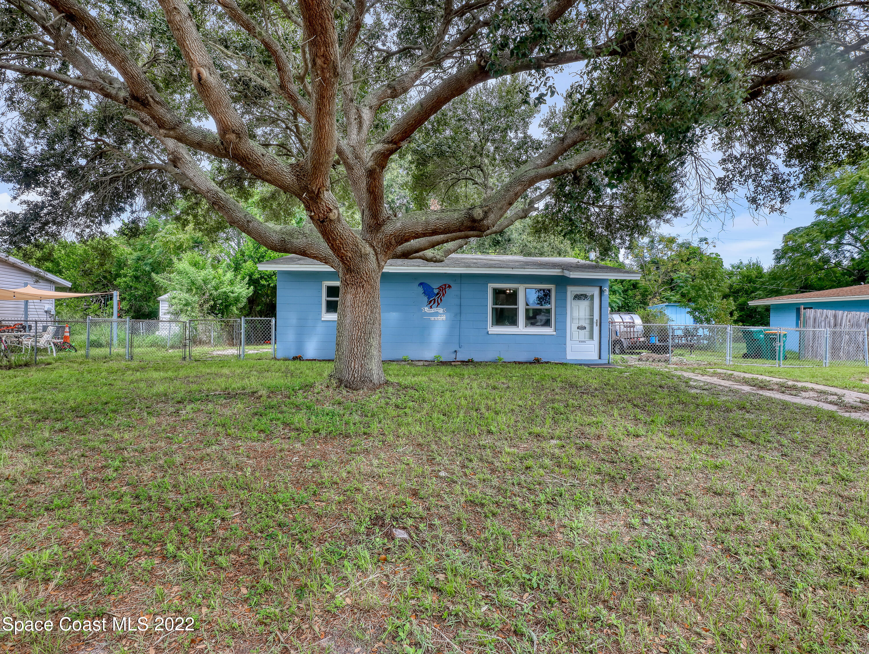 2156 King Richard Road Melbourne, FL 32935 - Photo 2 of 28 a view of a house with yard and tree s