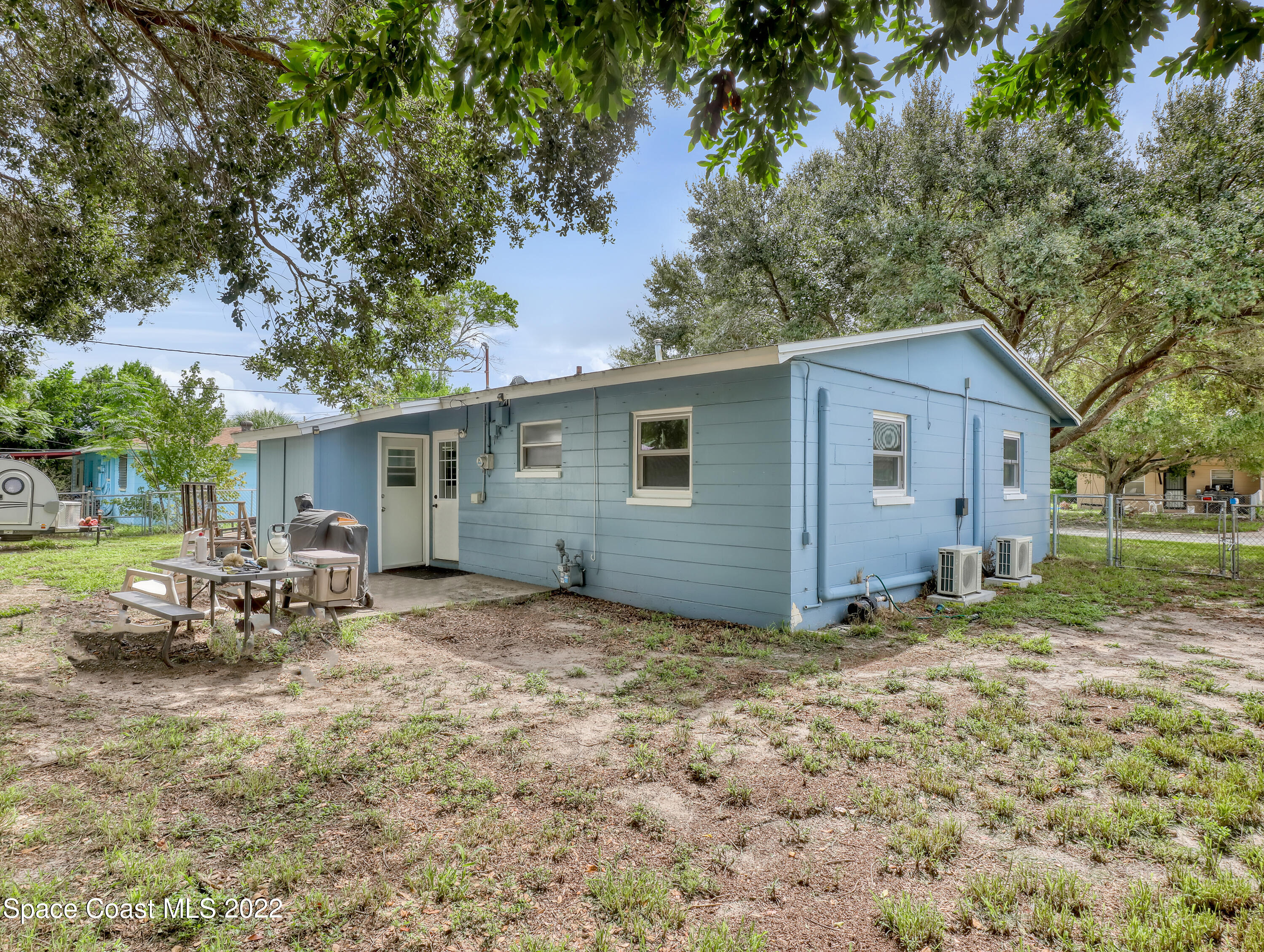 2156 King Richard Road Melbourne, FL 32935 - Photo 26 of 28 a view of a house with backyard and chairs