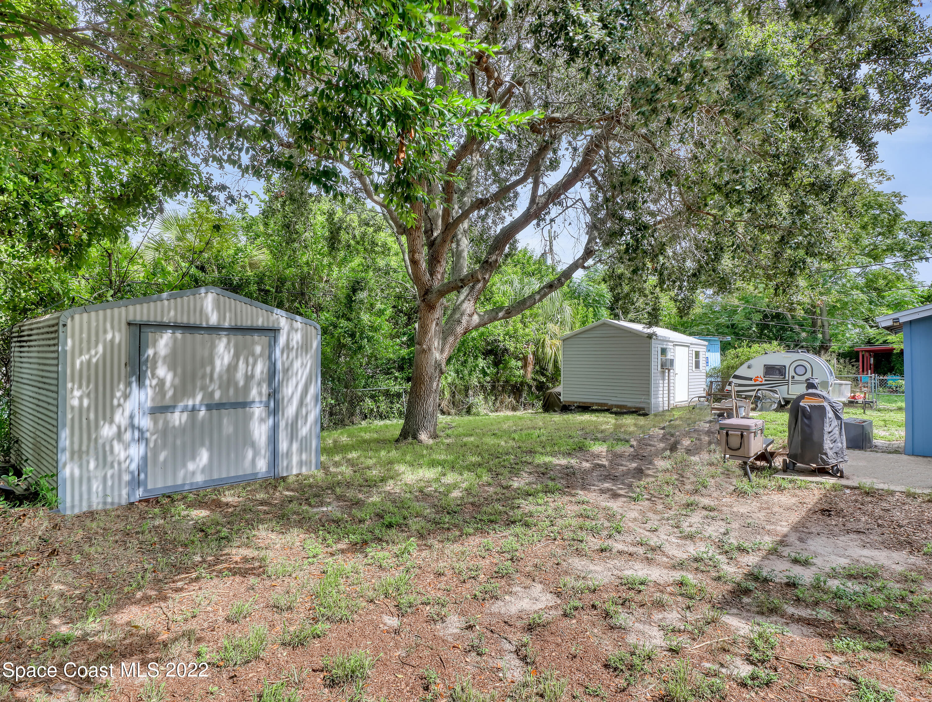 2156 King Richard Road Melbourne, FL 32935 - Photo 27 of 28 a backyard of a house with lots of green space