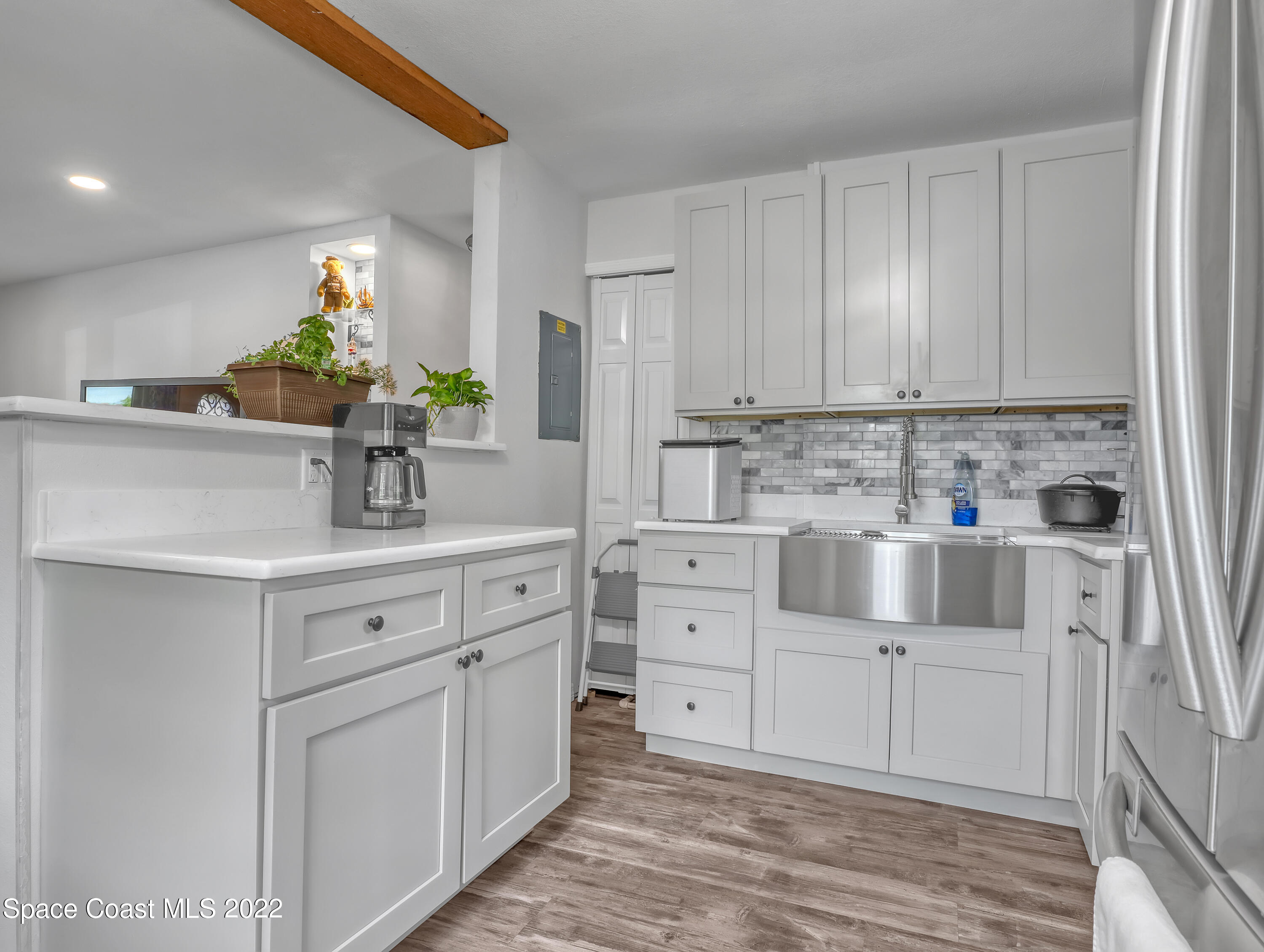2156 King Richard Road Melbourne, FL 32935 - Photo 10 of 28 a kitchen with white cabinets and sink