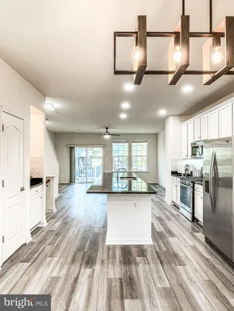 a view of a kitchen with cabinets and wooden floor