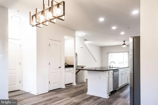 a view of a kitchen with a sink and refrigerator