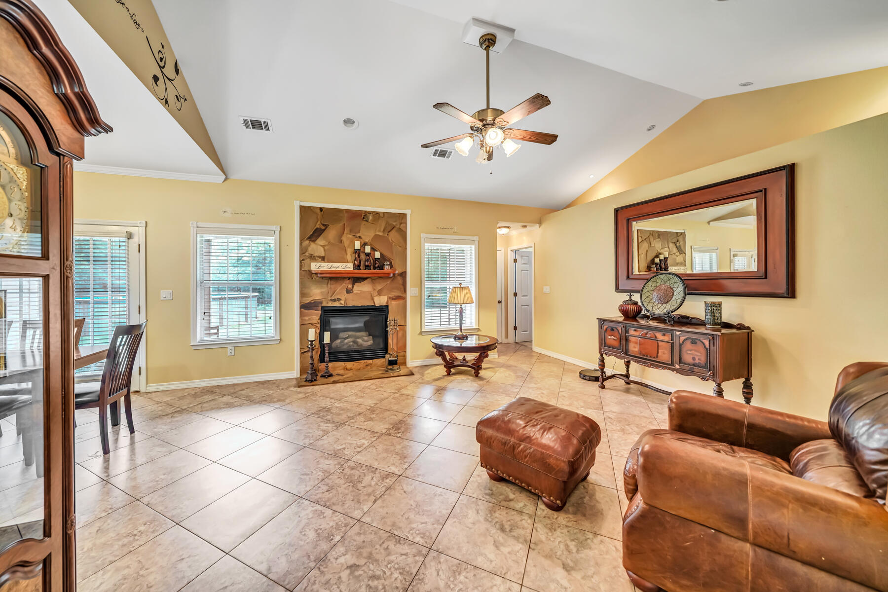 695 7 Oaks Road DeFuniak Springs, FL 32433 - Photo 19 of 47 a living room with furniture a fireplace and a flat screen tv