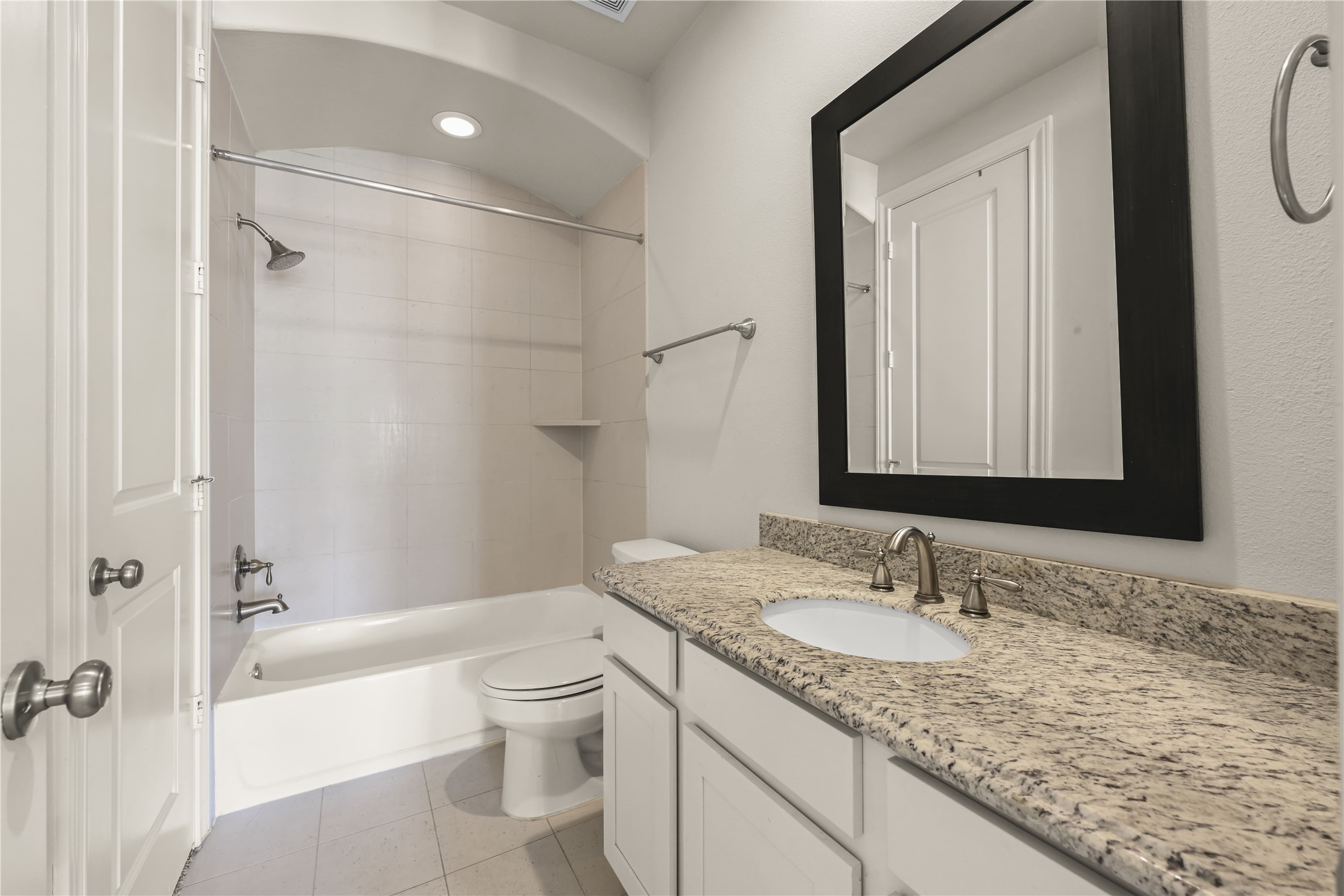 1027 St Charles Street Houston, TX 77003 - Photo 11 of 23 a bathroom with a granite countertop sink a toilet and shower