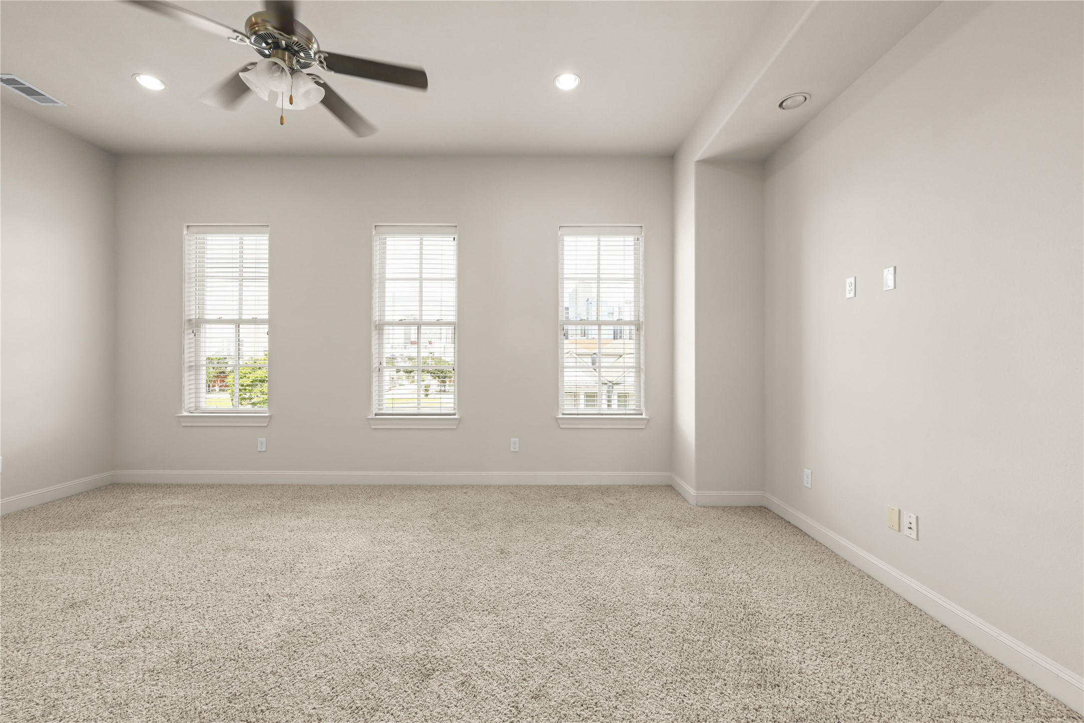 1027 St Charles Street Houston, TX 77003 - Photo 12 of 23 an empty room with windows and chandelier fan