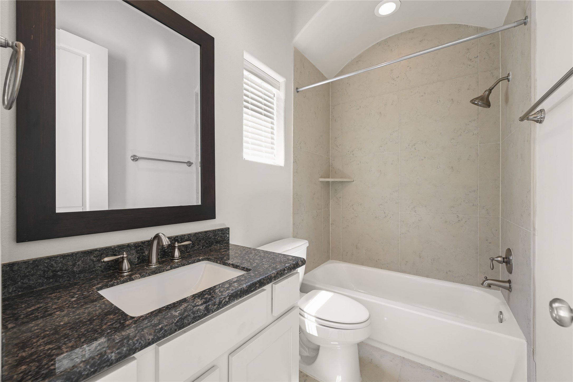 1027 St Charles Street Houston, TX 77003 - Photo 13 of 23 a bathroom with a granite countertop sink and a mirror