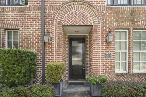 a kitchen with stainless steel appliances granite countertop a refrigerator a sink dishwasher a stove and a refrigerator with wooden floor