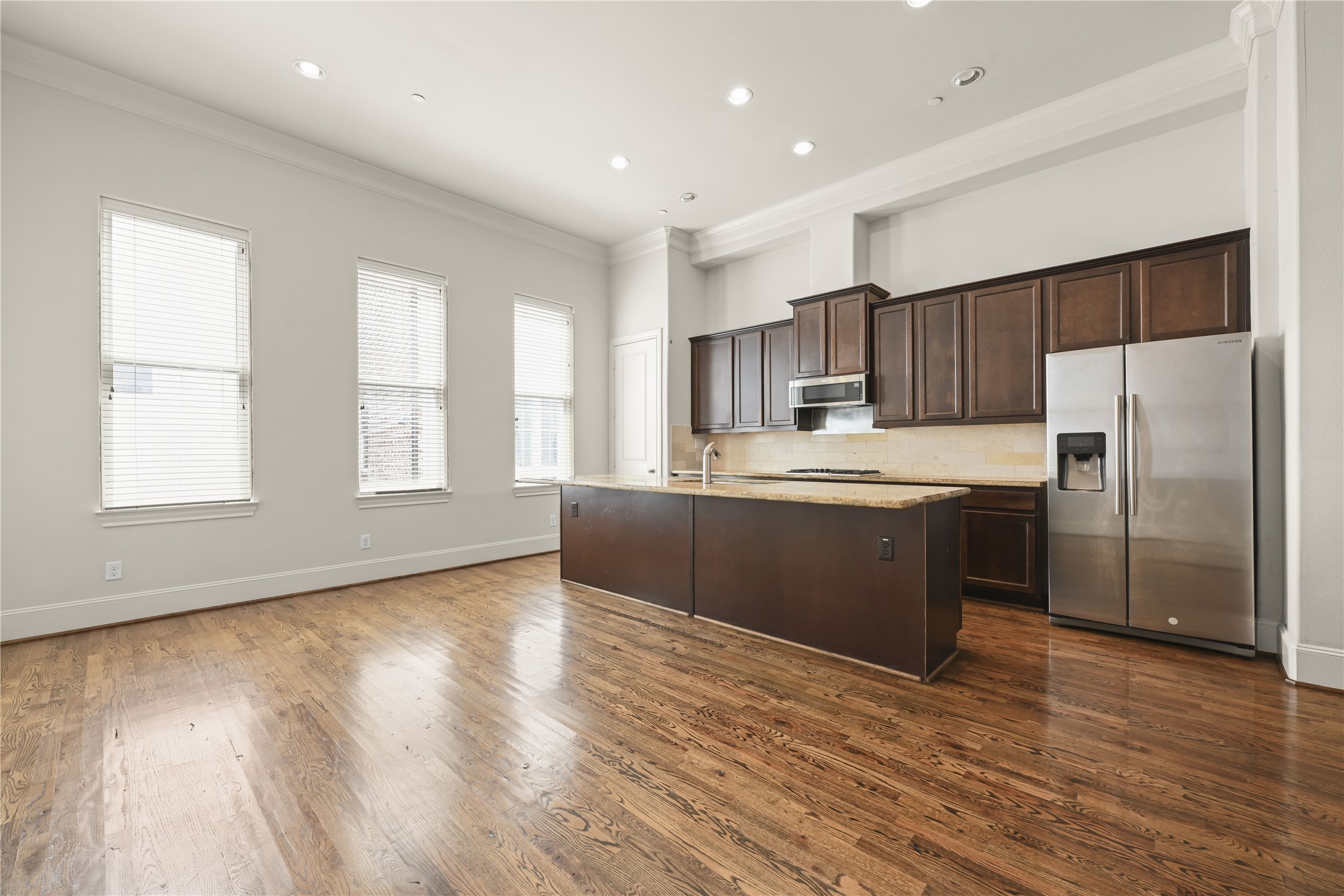 1027 St Charles Street Houston, TX 77003 - Photo 3 of 23 a kitchen with stainless steel appliances granite countertop a refrigerator a sink dishwasher a stove and a refrigerator with wooden floor