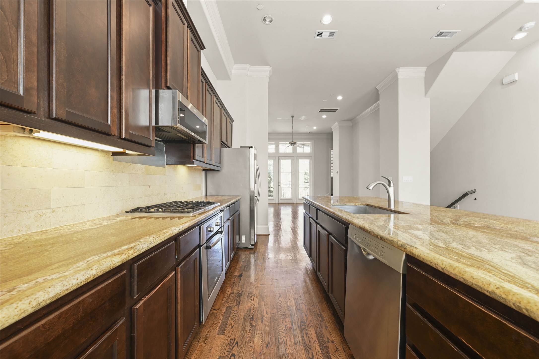 1027 St Charles Street Houston, TX 77003 - Photo 4 of 23 a kitchen with granite countertop stainless steel appliances and wooden cabinets