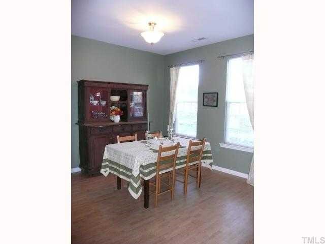 4355 Sugarbend Way Raleigh, NC 27606 - Photo 7 of 12 Bright and sunny dining room w/ tall windows and 9 foot ceilings. Window treatments convey!