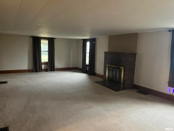 an empty room with windows and closet