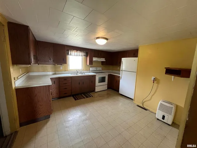 an empty room with closet and windows