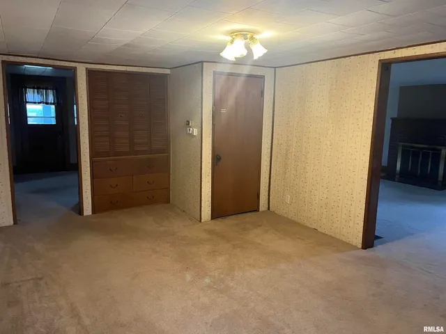 a view of a livingroom with wooden floor and stairs