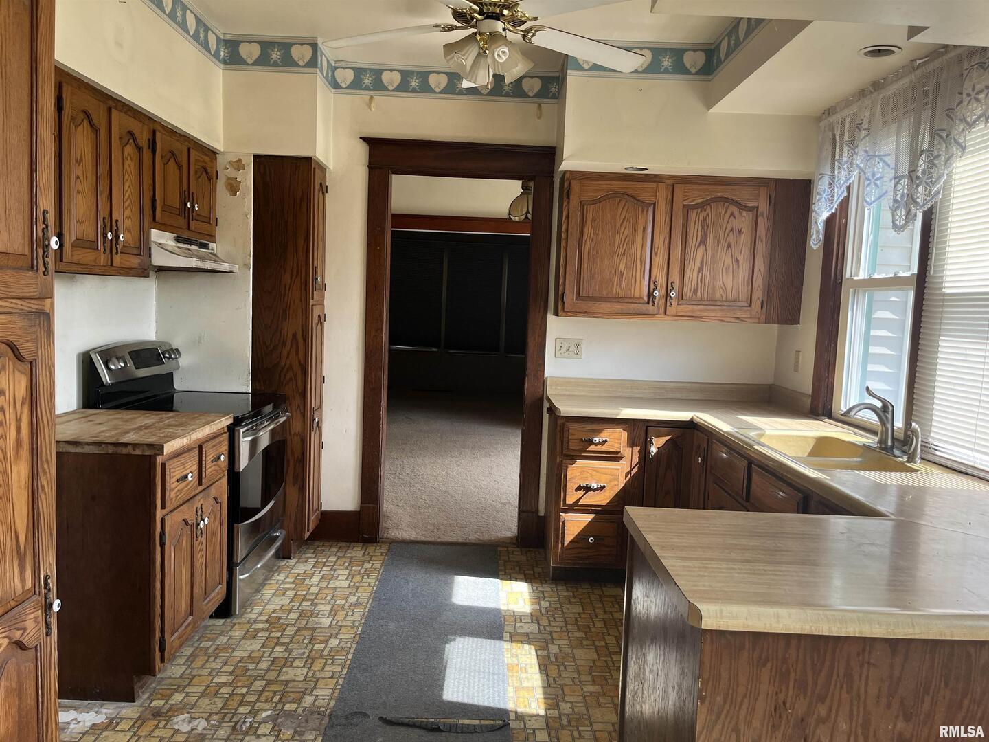 2283 East 2750th Street Kewanee, IL 61443 - Photo 43 of 58 a kitchen with a sink stove and refrigerator