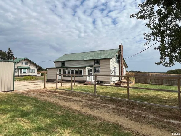 a view of house with a backyard