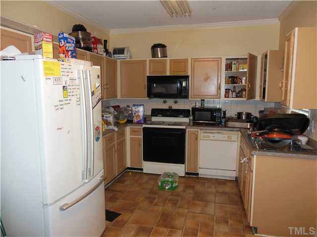 4022 Beaufain Street Raleigh, NC 27604 - Photo 2 of 6 a kitchen with a refrigerator and a stove top oven