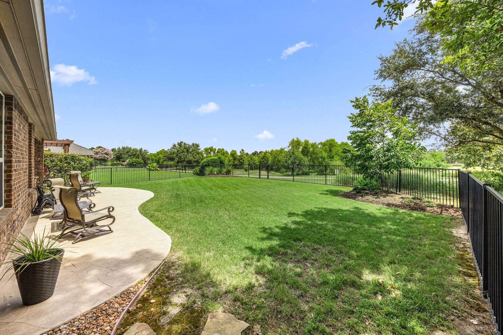 27642 Linden Ridge Lane Fulshear, TX 77441 - Photo 4 of 42 The expansive Patio extends the entire length of the home, providing ample space for outdoor seating, entertaining, and dining while enjoying the peaceful views of the nature reserve. It's the perfect place to relax and take in the tranquil surroundings year-round.