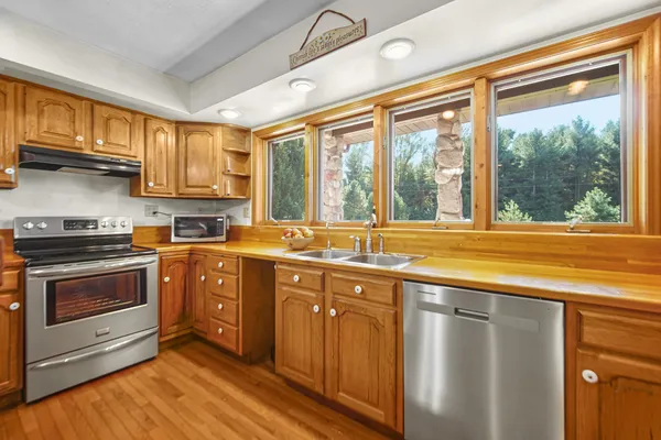 a kitchen with stainless steel appliances granite countertop a stove and a sink