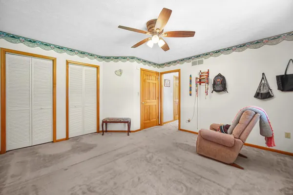 a living room with furniture and a ceiling fan