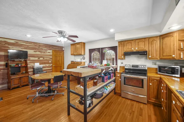 a kitchen with stainless steel appliances granite countertop a stove and cabinets
