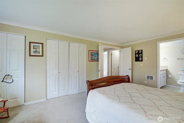 a bedroom with a bed and cabinets