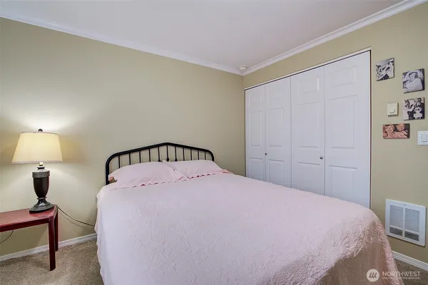 a bedroom with a bed and a lamp