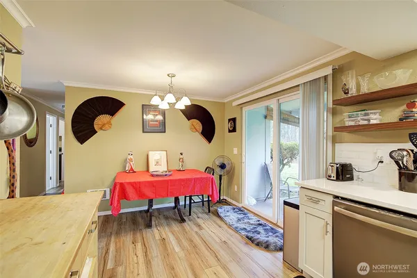 a bedroom with a bed dresser and window