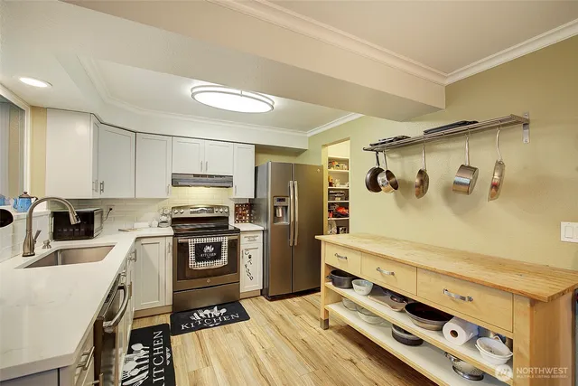a kitchen with a stove and a refrigerator