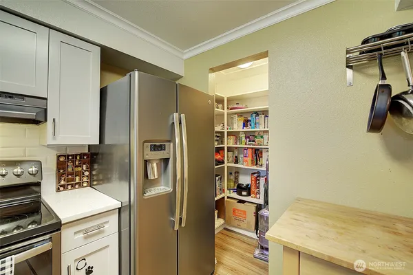 a kitchen with stainless steel appliances a refrigerator and a stove top oven