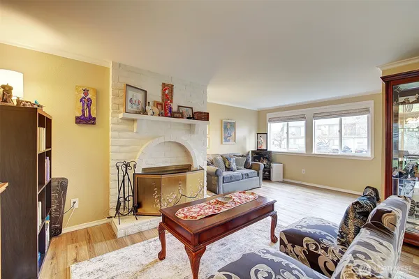 a living room with furniture a fireplace and a window