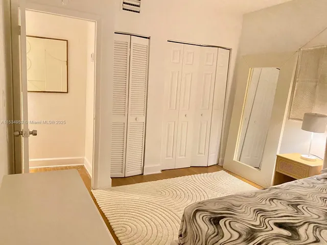 a bedroom with a bed and a mirror