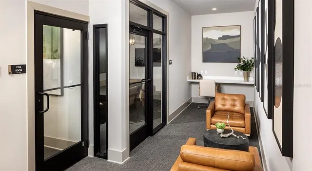a hallway with white doors wooden floor and glass door